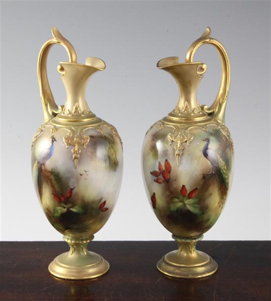 A pair of Royal Worcester peacock painted ewers, c.1905, 20.3cm (8in.), one restored